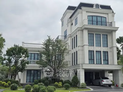 Luxurious multi-story home with elegant facade and lush landscaping