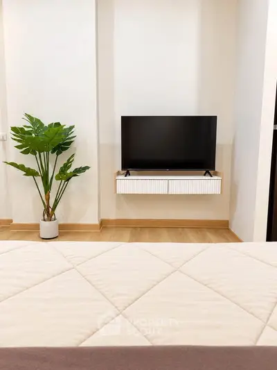 Modern bedroom with wall-mounted TV and stylish decor