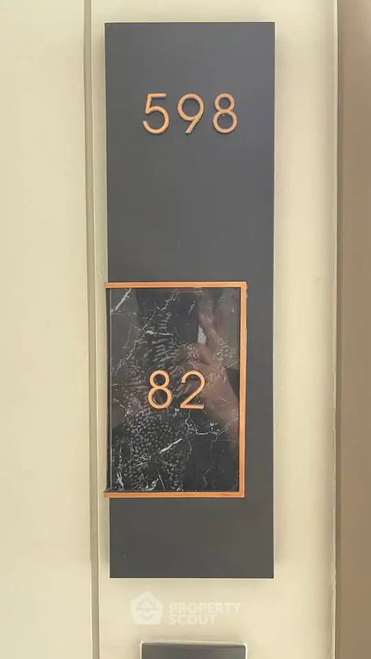 Modern apartment number plaque with sleek design and elegant finish.