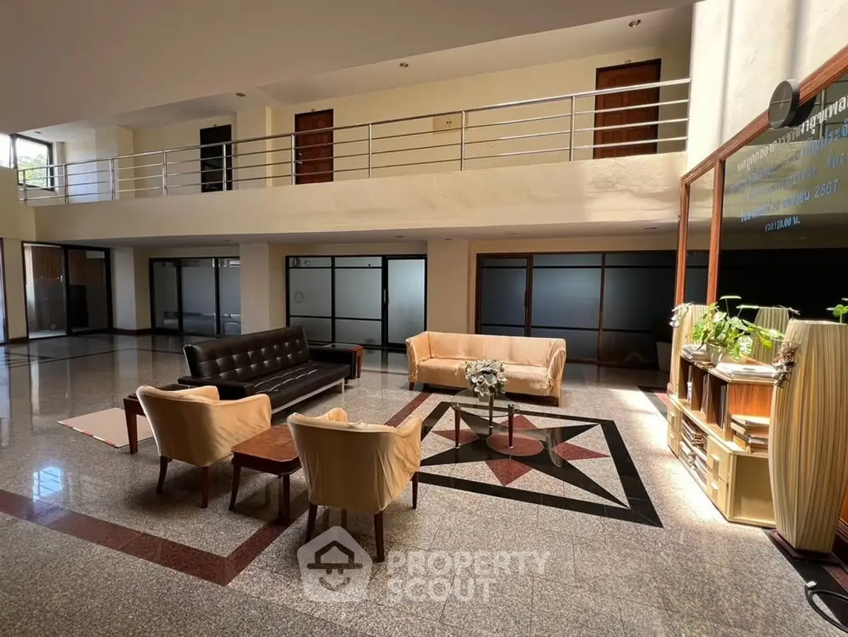 Spacious lobby with modern seating and natural light in a residential building.