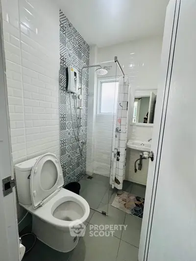 Modern bathroom with glass shower and stylish tile accents
