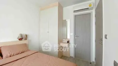 Modern bedroom with built-in wardrobe and air conditioning in a stylish apartment.