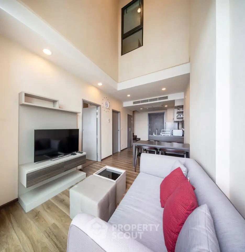 Spacious modern living room with high ceiling and stylish decor