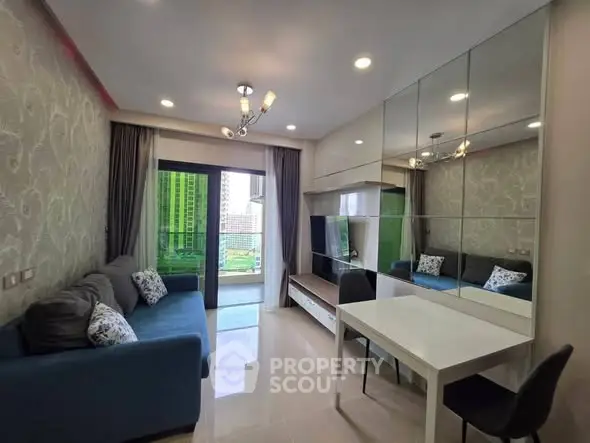 Modern living room with mirrored wall and balcony view in high-rise apartment.