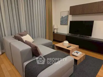 Modern living room with stylish furniture and large TV, perfect for relaxation and entertainment.