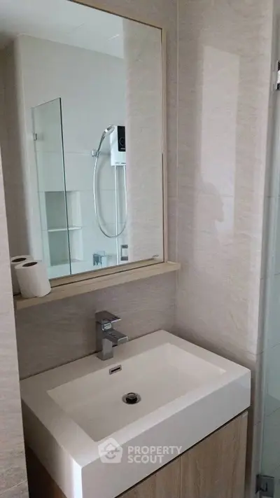Modern bathroom with sleek sink and mirror design