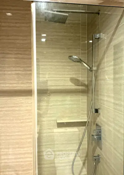 Modern bathroom with glass shower enclosure and sleek fixtures