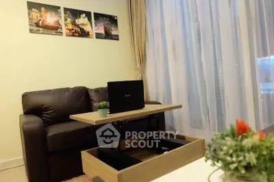 Cozy living room with modern sofa and adjustable coffee table, perfect for relaxation and work.
