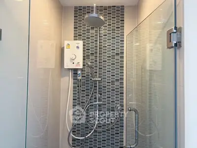 Modern bathroom shower with sleek glass doors and stylish tile design.