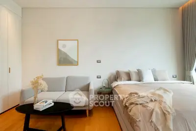 Modern bedroom with cozy sofa and stylish decor, perfect for relaxation and comfort.