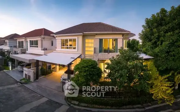 Stunning two-story house with modern design and lush greenery in a serene neighborhood.