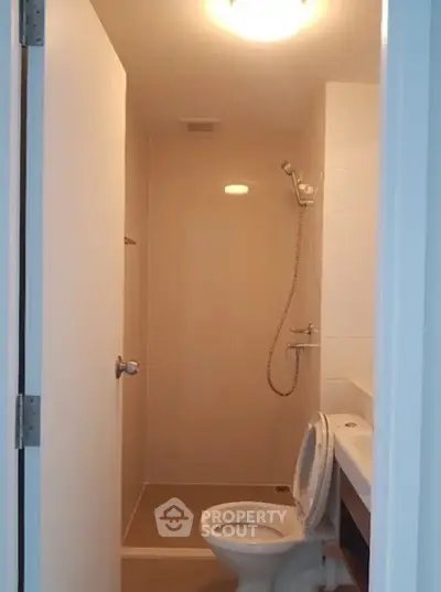 Compact bathroom with shower and toilet in modern apartment