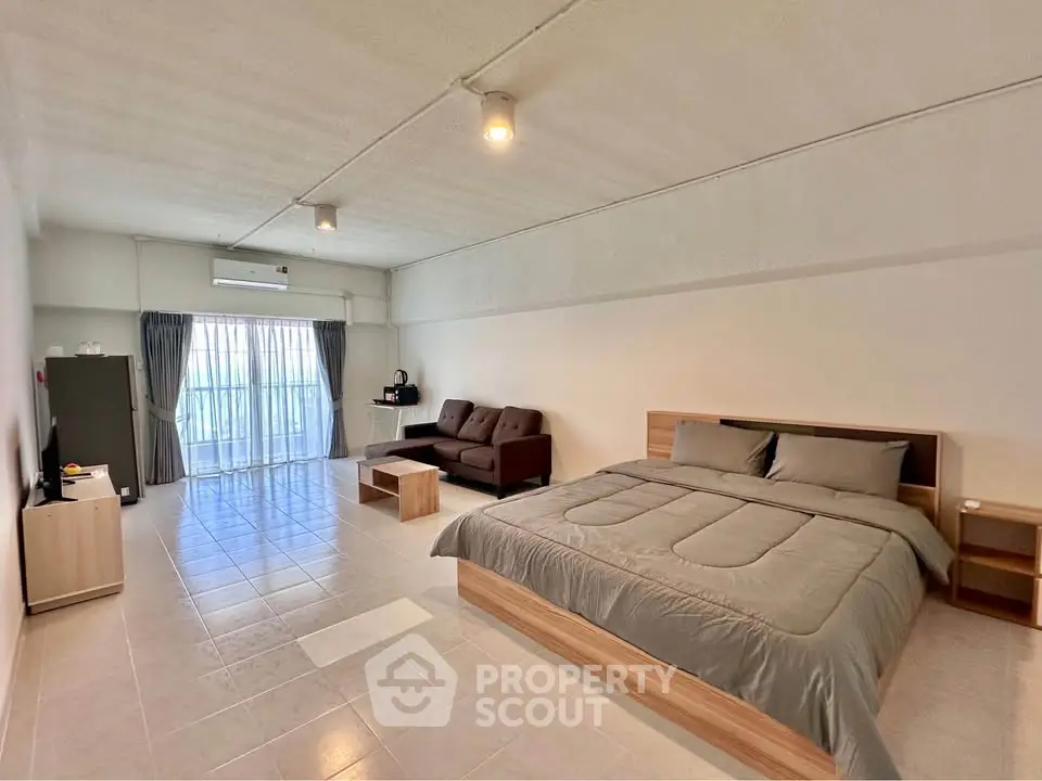 Spacious modern bedroom with large windows and minimalist decor