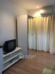 Cozy bedroom with mirrored wardrobe and TV stand, perfect for modern living.