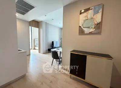 Modern apartment interior with stylish decor and open layout, featuring a sleek dining area and contemporary artwork.