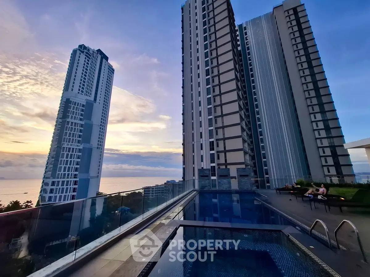 Stunning high-rise buildings with a rooftop pool and ocean view at sunset.