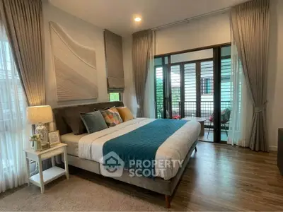 Spacious bedroom with elegant decor and balcony access in modern home