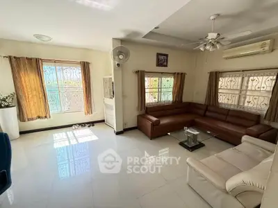 Spacious living room with large windows and modern furniture