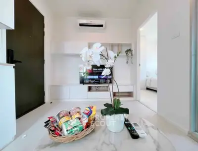 Modern living room with sleek design, featuring a marble table, TV, and air conditioning, perfect for relaxation.