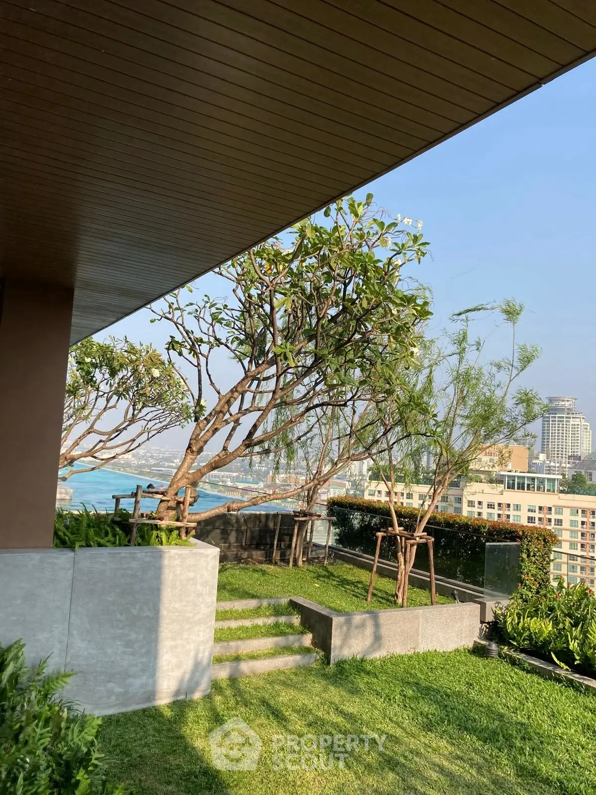 Stunning rooftop garden with panoramic city and ocean views, perfect for relaxation and entertainment.