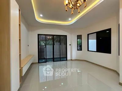 Spacious modern living room with elegant lighting and large windows for natural light.