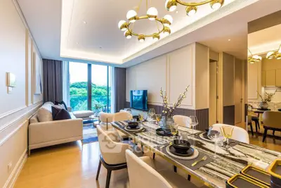 Luxurious modern living room with elegant dining area and scenic view, featuring stylish lighting and decor.