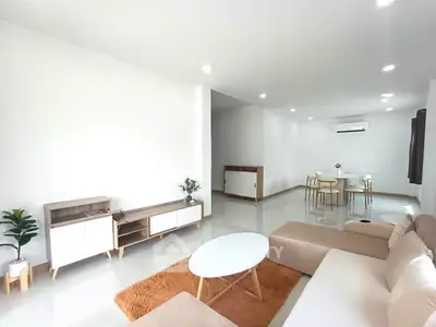 Spacious modern living room with elegant furniture and bright lighting