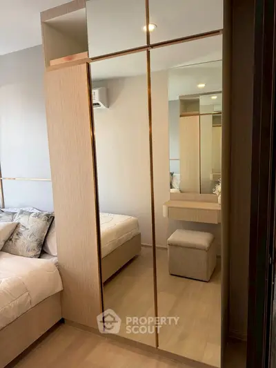 Modern bedroom with mirrored wardrobe and cozy decor
