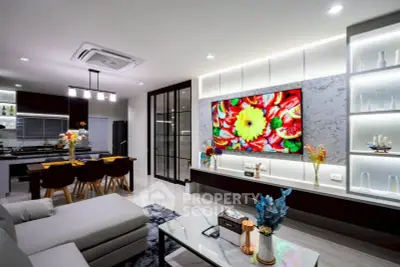 Modern open-layout living room with stylish decor and vibrant wall art