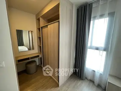 Modern bedroom with built-in wardrobe and vanity in a bright apartment