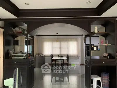 Spacious living room with elegant dark wood cabinetry and dining area, perfect for family gatherings.