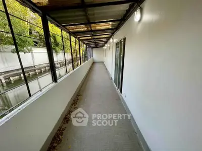 Spacious covered balcony with modern design and natural light