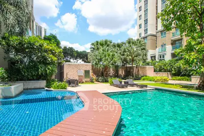 Luxurious residential pool area with lush greenery and modern architecture