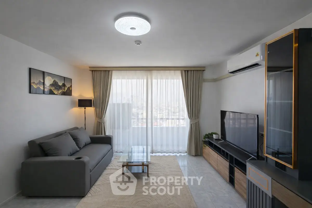 Modern living room with sleek furniture and large window view