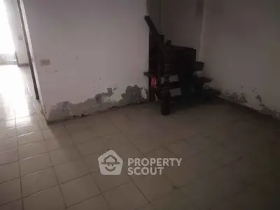 Spacious interior with staircase, ideal for renovation projects.