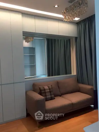 Modern living room with elegant sofa and stylish lighting in a cozy apartment.
