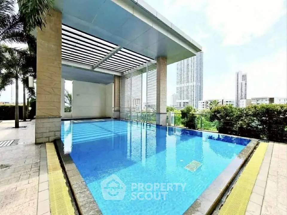 Luxurious rooftop pool with city skyline view and modern design.