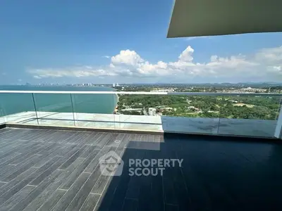 Stunning balcony with panoramic ocean and city views, perfect for relaxation and entertainment.