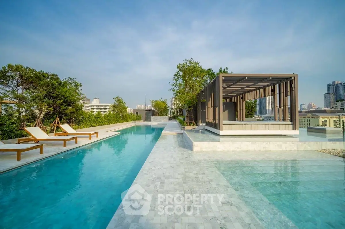 Luxurious rooftop pool with modern cabana and city skyline view