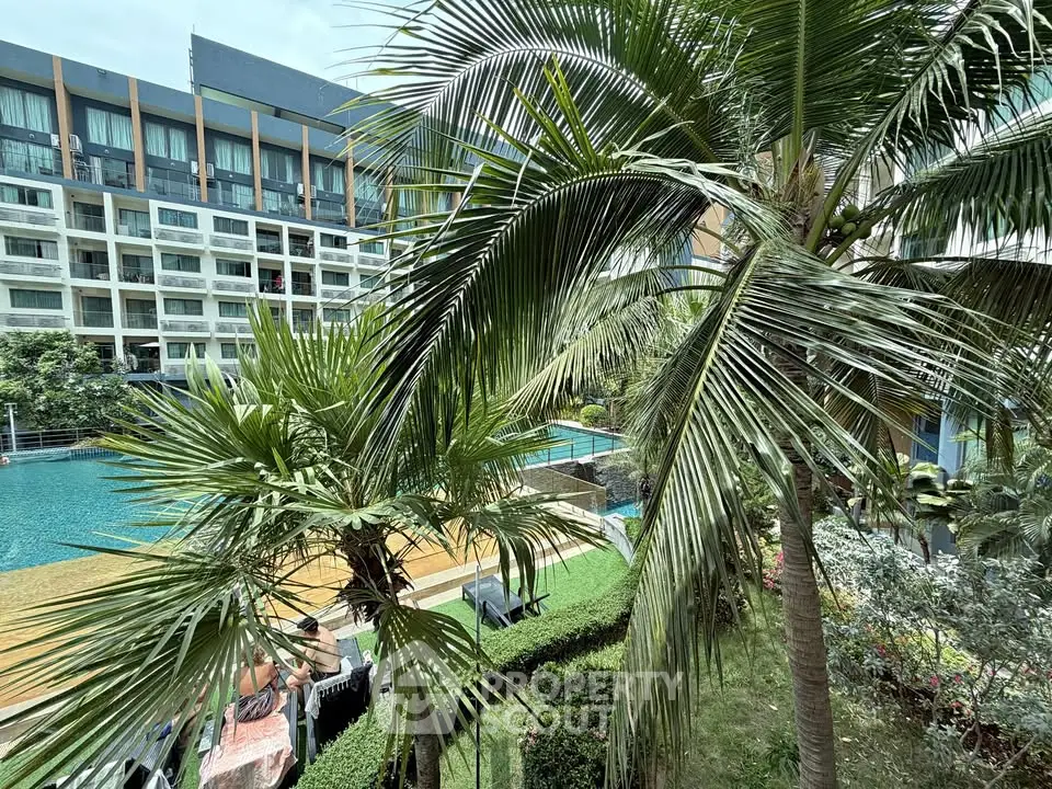 Luxurious apartment complex with pool and lush greenery, perfect for relaxation and modern living.