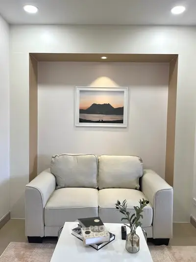 Cozy living room with elegant decor and framed mountain artwork
