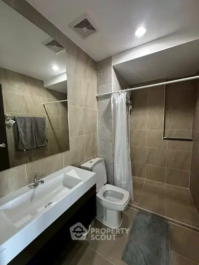 Modern bathroom with sleek fixtures and spacious shower area