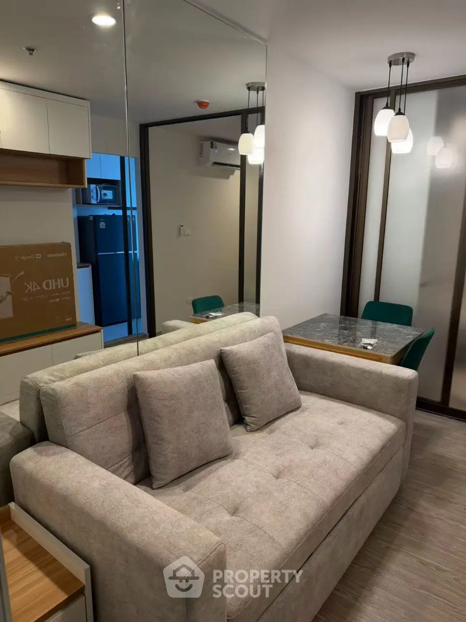 Modern living room with cozy sofa and elegant dining area in stylish apartment.