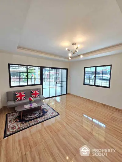 Spacious living room with modern decor and large windows for natural light.