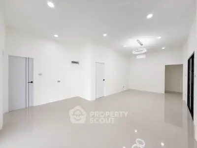 Spacious modern living room with elegant lighting and glossy tiled flooring.