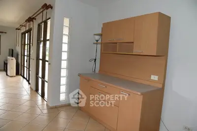 Spacious living area with modern cabinetry and large windows for natural light.