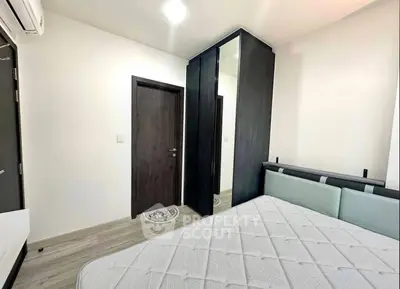 Modern bedroom with sleek wardrobe and comfortable bed in minimalist design.