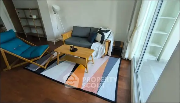 Stylish living room with modern furniture and large window for natural light.