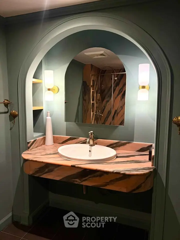 Elegant bathroom with marble sink and stylish lighting, perfect for luxury real estate listings.