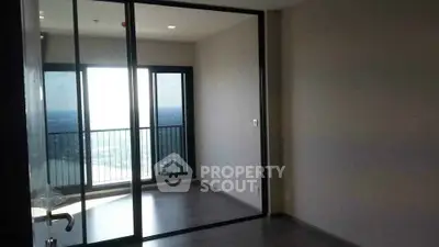 Spacious room with floor-to-ceiling windows offering stunning river views and a private balcony.